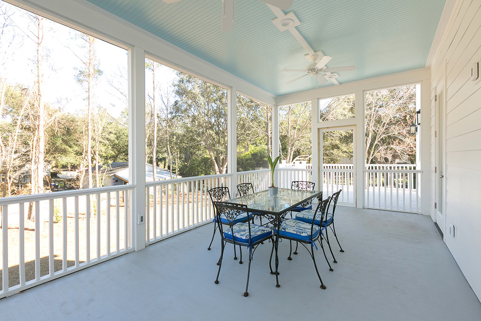 Mid-sized traditional front yard verandah in Charleston with decking and a roof extension.