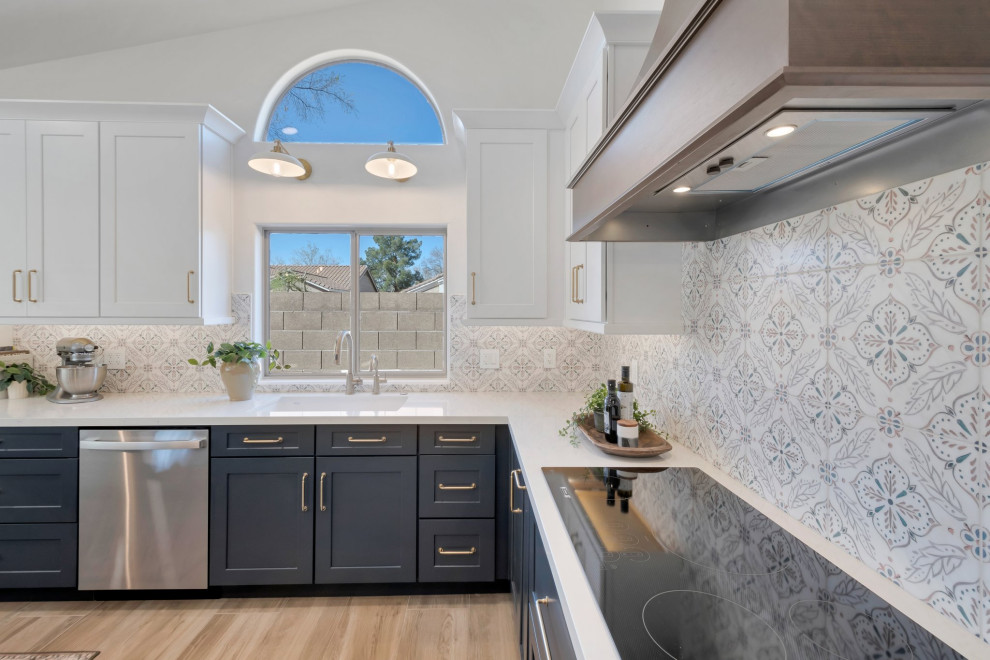 Large transitional l-shaped porcelain tile, brown floor and vaulted ceiling eat-in kitchen photo in Phoenix with an undermount sink, shaker cabinets, blue cabinets, quartzite countertops, multicolored backsplash, mosaic tile backsplash, stainless steel appliances, two islands and white countertops