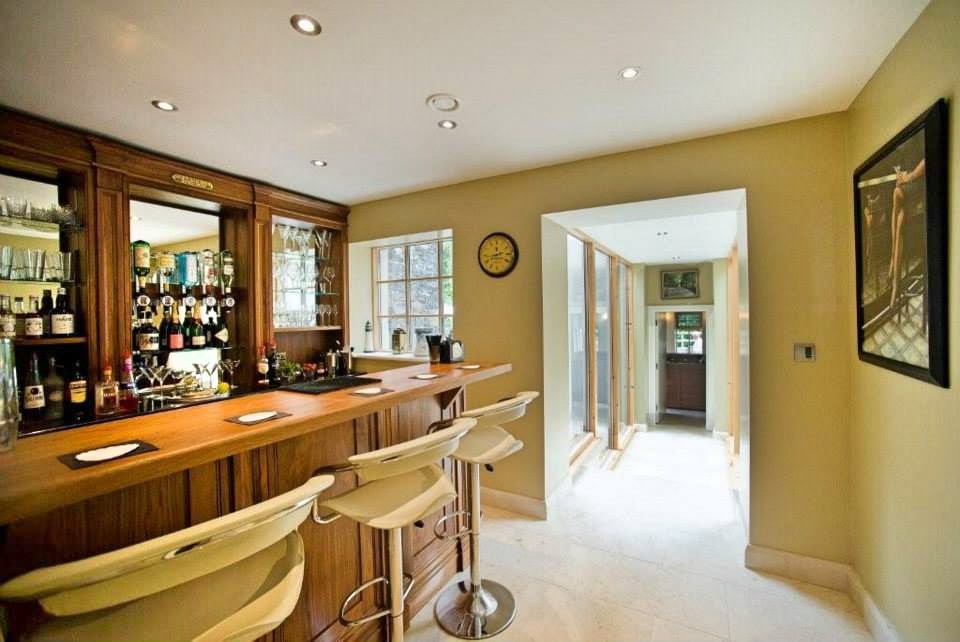 Inspiration for a large contemporary galley wet bar in Other with beige floors.