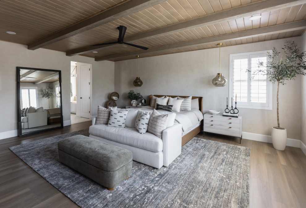 Bedroom - transitional medium tone wood floor, brown floor, exposed beam and wood ceiling bedroom idea in Phoenix with beige walls