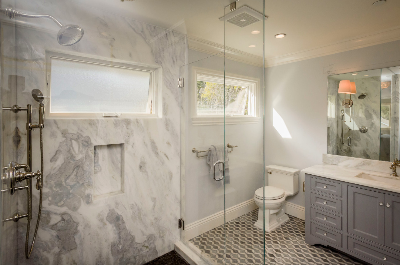 Example of a mid-sized trendy master gray tile, white tile and stone slab mosaic tile floor corner shower design in San Francisco with recessed-panel cabinets, gray cabinets, marble countertops, a one