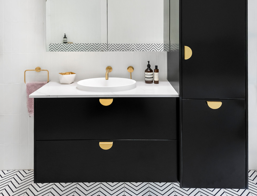 This is an example of a large contemporary kids bathroom in Brisbane with black cabinets, a freestanding tub, an open shower, a wall-mount toilet, black and white tile, ceramic tile, white walls, ceramic floors, a vessel sink, marble benchtops, black floor, an open shower, white benchtops, a single vanity, a floating vanity and flat-panel cabinets.