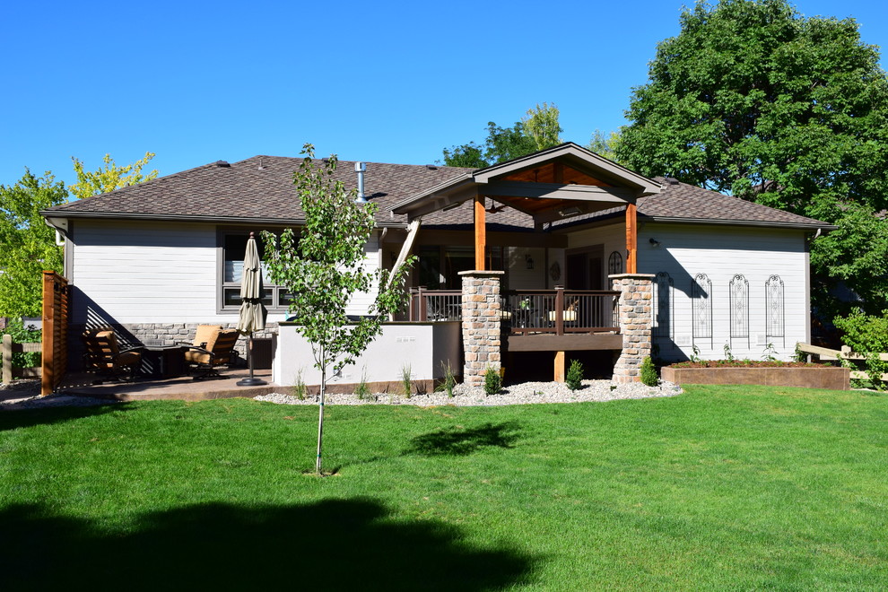 Inspiration for a mid-sized transitional backyard outdoor kitchen deck remodel in Denver with a roof extension