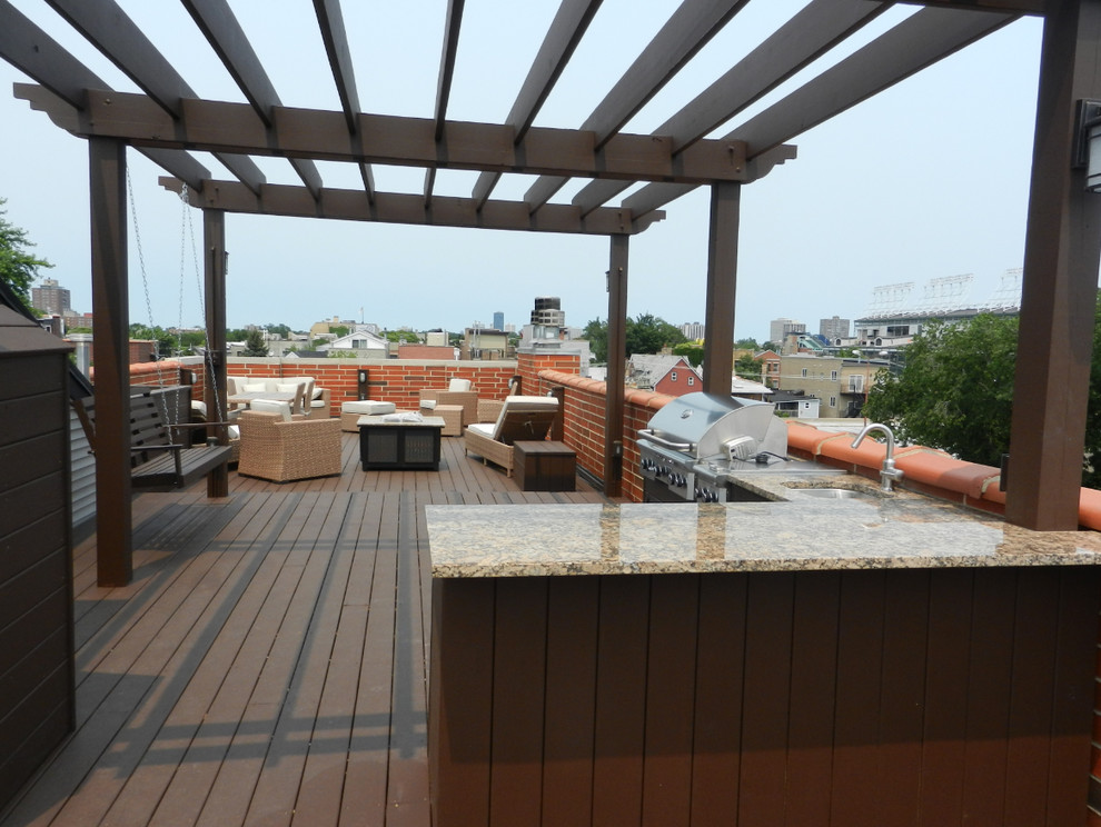 Photo of a large contemporary rooftop deck in Chicago with an outdoor kitchen and a pergola.