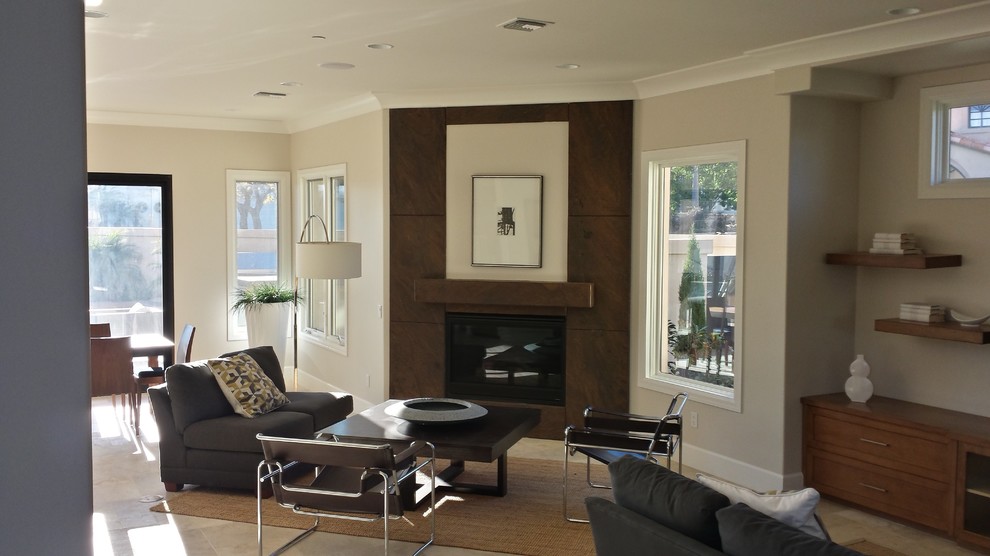 This is an example of a mid-sized modern formal enclosed living room in Orange County with beige walls, ceramic floors, a standard fireplace, a tile fireplace surround, no tv and beige floor.