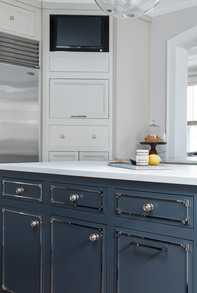 Eat-in kitchen - mid-sized transitional medium tone wood floor and brown floor eat-in kitchen idea in Chicago with a farmhouse sink, beaded inset cabinets, blue cabinets, marble countertops, white backsplash, ceramic backsplash, stainless steel appliances, two islands and white countertops