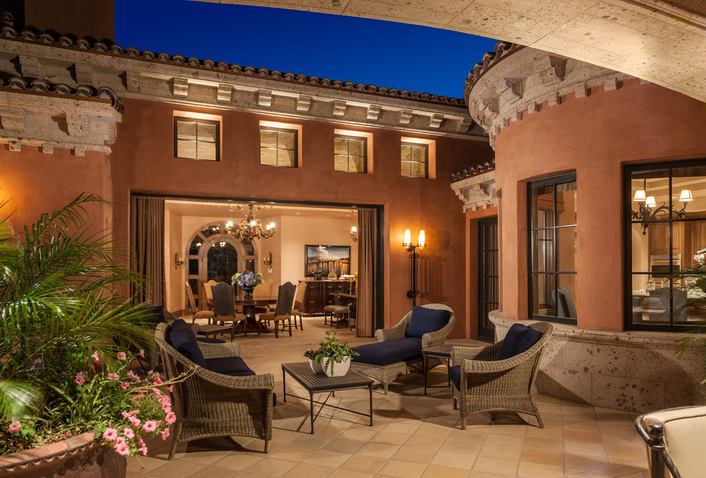 Inspiration for a mediterranean patio in Orange County with tile and no cover.