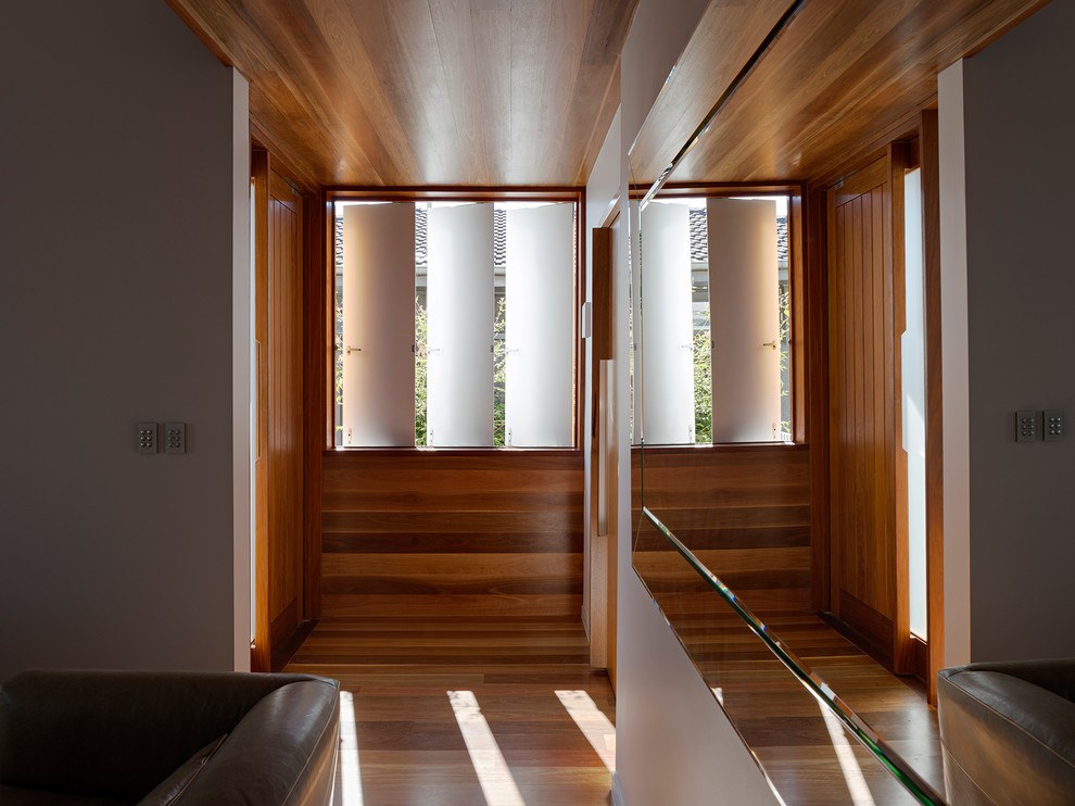 This is an example of a contemporary hallway in Brisbane with medium hardwood floors.