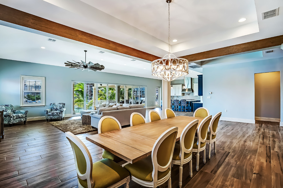 This is an example of a large transitional open plan dining in Tampa with blue walls and porcelain floors.
