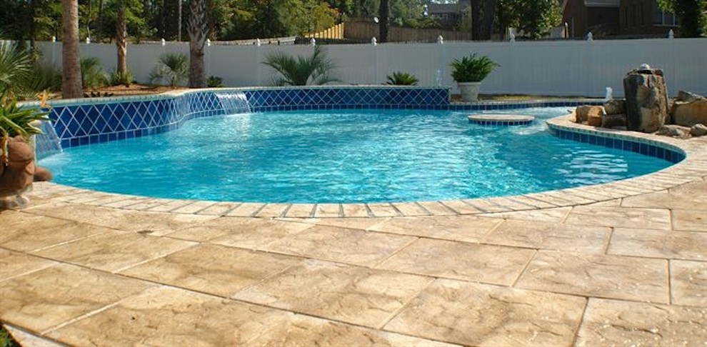Pool fountain - mid-sized backyard stone and rectangular natural pool fountain idea