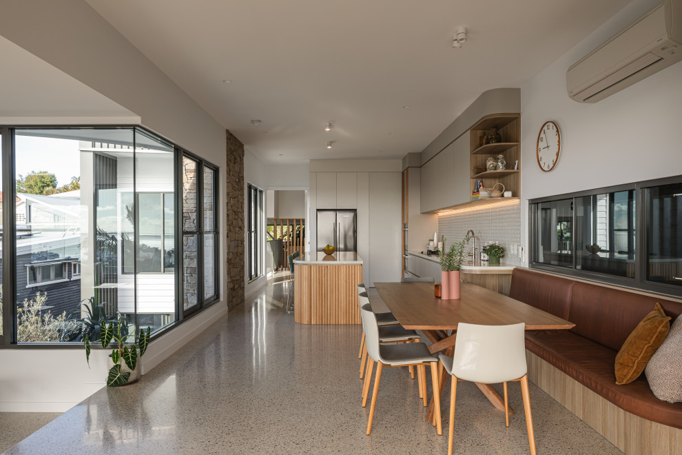 This is an example of a large contemporary dining room in Brisbane.