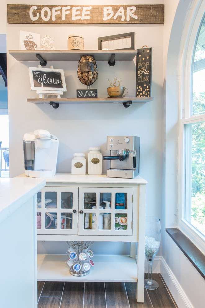Inspiration for a large transitional u-shaped porcelain tile and brown floor eat-in kitchen remodel with an undermount sink, shaker cabinets, white cabinets, quartz countertops, white backsplash, marble backsplash, stainless steel appliances and two islands