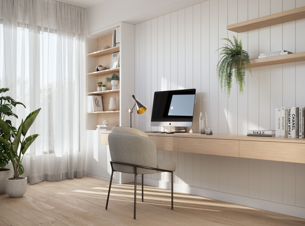 Modelo de despacho actual con paredes blancas, suelo de madera clara, escritorio empotrado, suelo marrón y boiserie