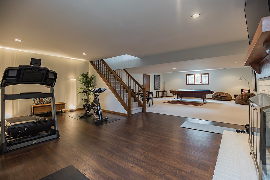 Traditional home gym in Phoenix with white walls and bamboo floors.