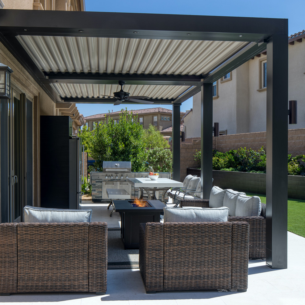 This is an example of a mid-sized contemporary backyard patio in Phoenix with a pergola.