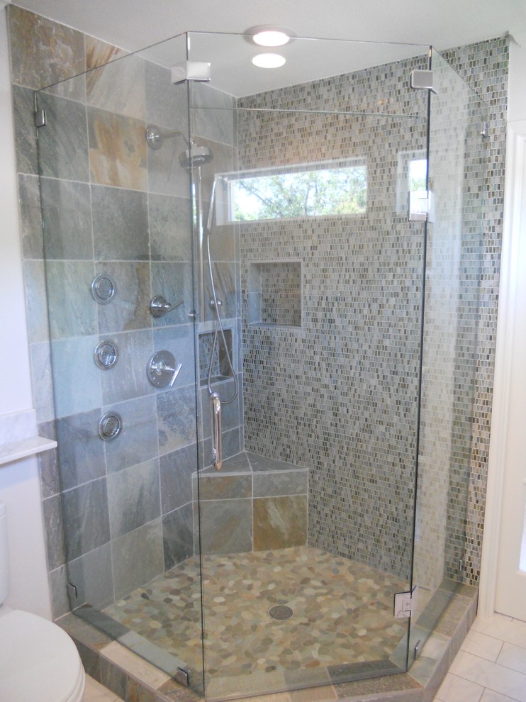 Contemporary bathroom in Dallas with a corner shower, multi-coloured tile and stone tile.