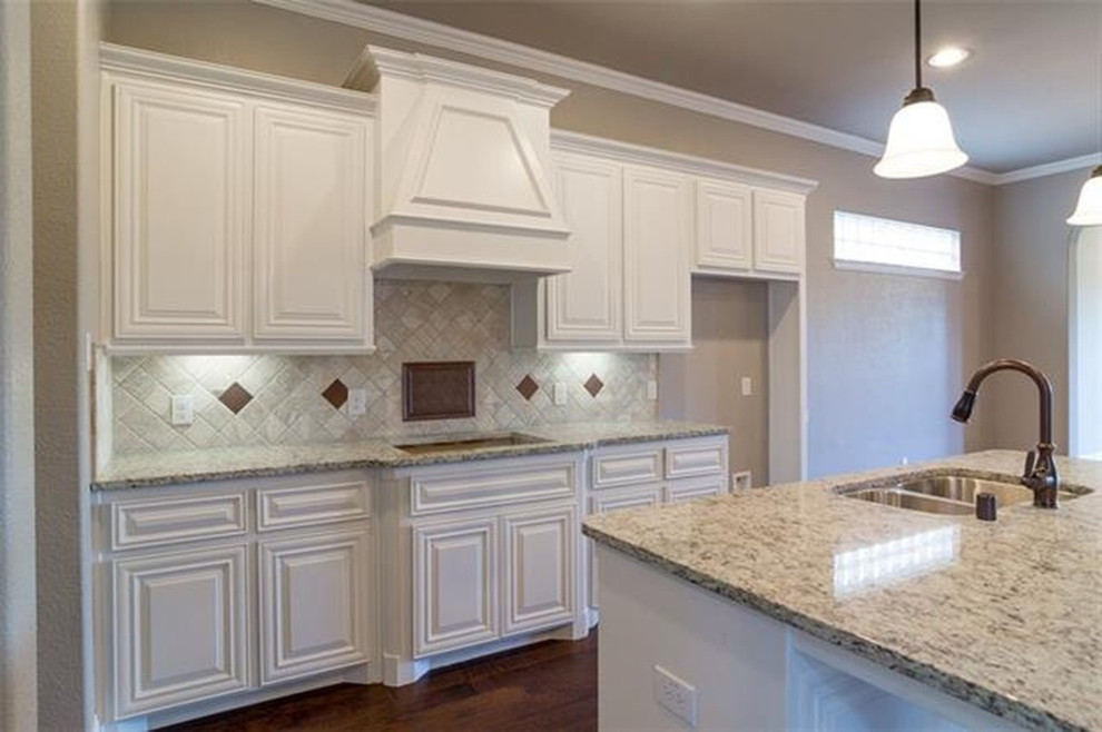 Open concept kitchen - large transitional l-shaped dark wood floor open concept kitchen idea with raised-panel cabinets, white cabinets, beige backsplash, colored appliances, an island and a double-bowl sink