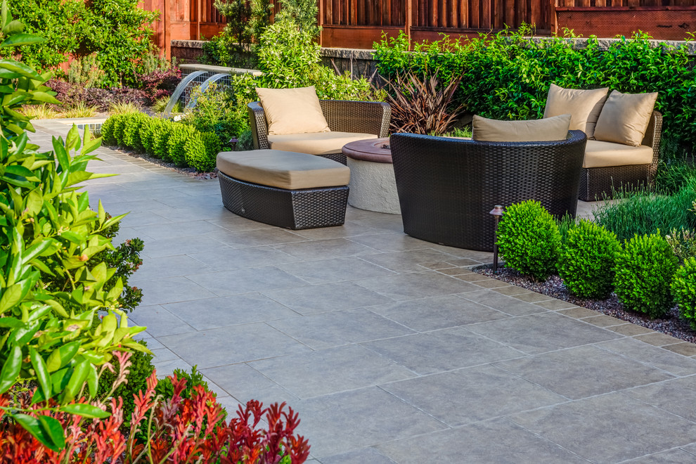 This is an example of a small mediterranean backyard patio in San Francisco with stamped concrete.