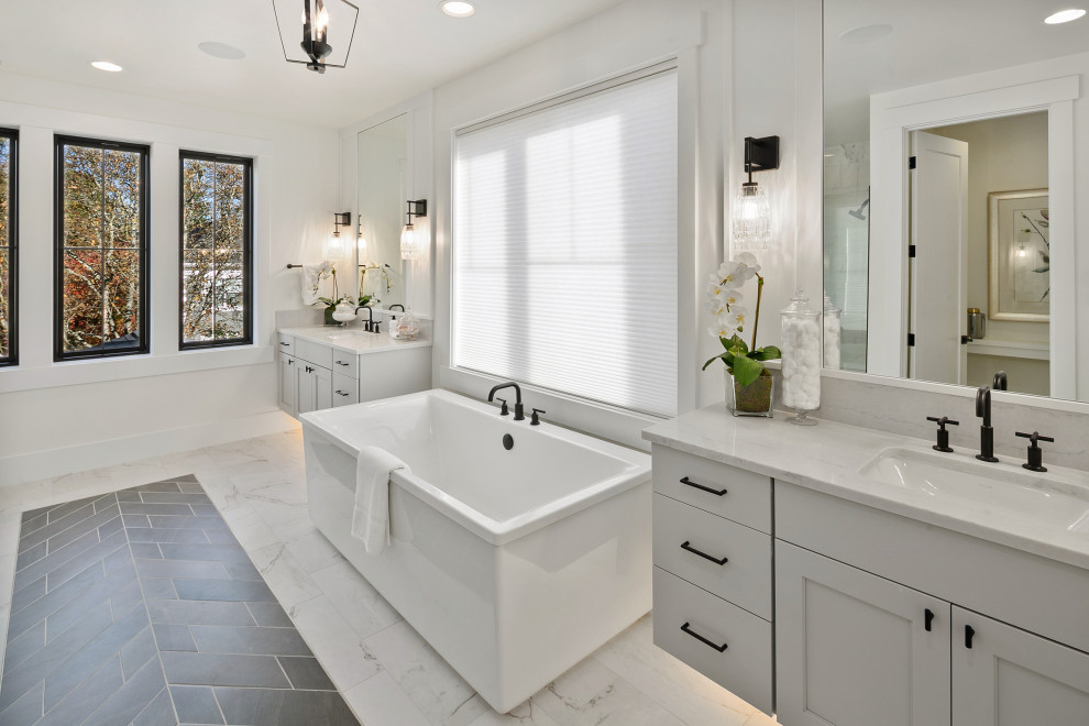 Inspiration for a mid-sized cottage master white tile porcelain tile, multicolored floor and double-sink bathroom remodel in Seattle with recessed-panel cabinets, gray cabinets, white walls, an undermount sink, quartz countertops, a hinged shower door, white countertops and a floating vanity