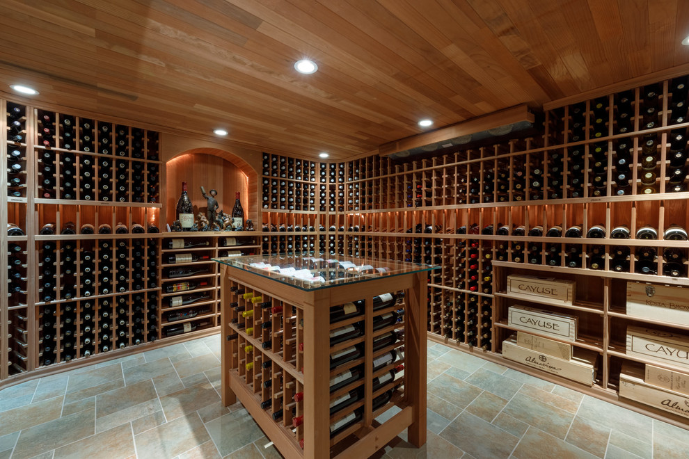 Photo of a large traditional wine cellar in Other with porcelain floors, storage racks and multi-coloured floor.