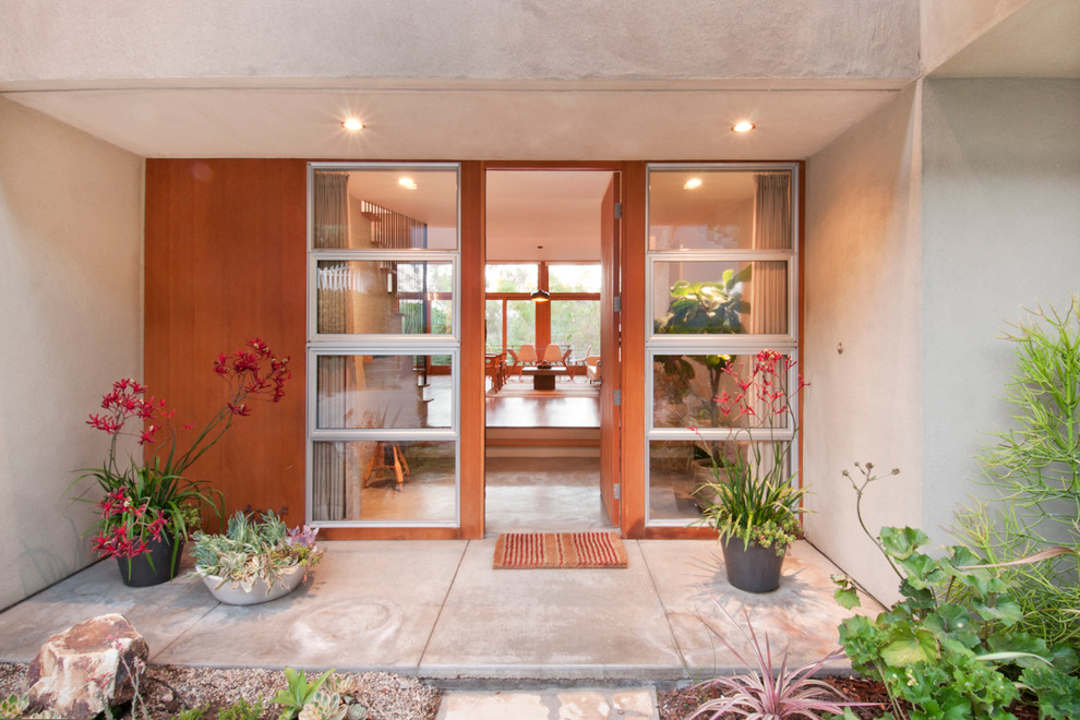 Contemporary front door in Los Angeles with a single front door and a medium wood front door.