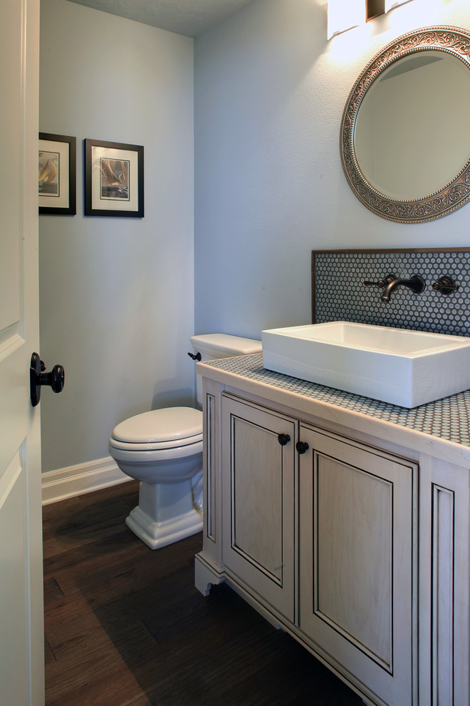 Photo of a mid-sized beach style powder room in Portland with light wood cabinets, a one-piece toilet, blue walls, medium hardwood floors and a drop-in sink.