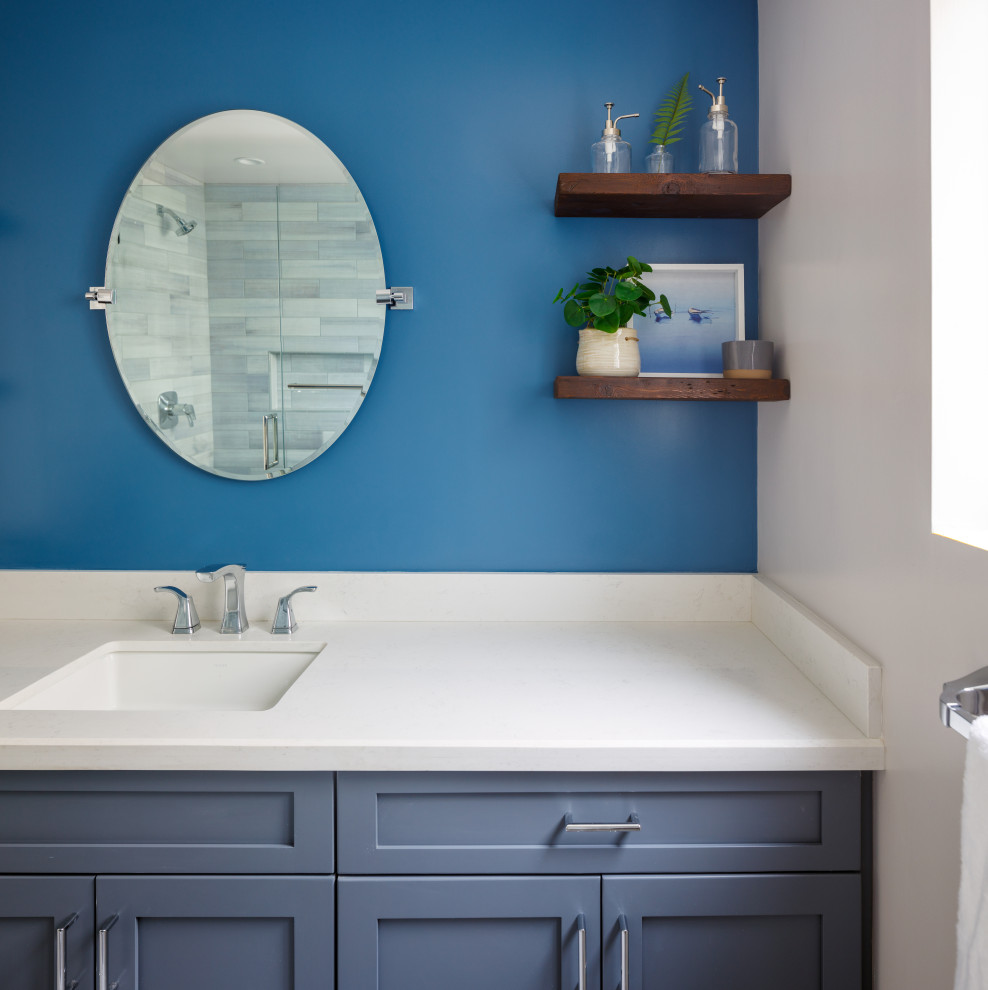 Design ideas for a small transitional 3/4 bathroom in Los Angeles with shaker cabinets, blue cabinets, a one-piece toilet, blue tile, porcelain floors, an undermount sink, engineered quartz benchtops, grey floor, white benchtops, a single vanity and a built-in vanity.