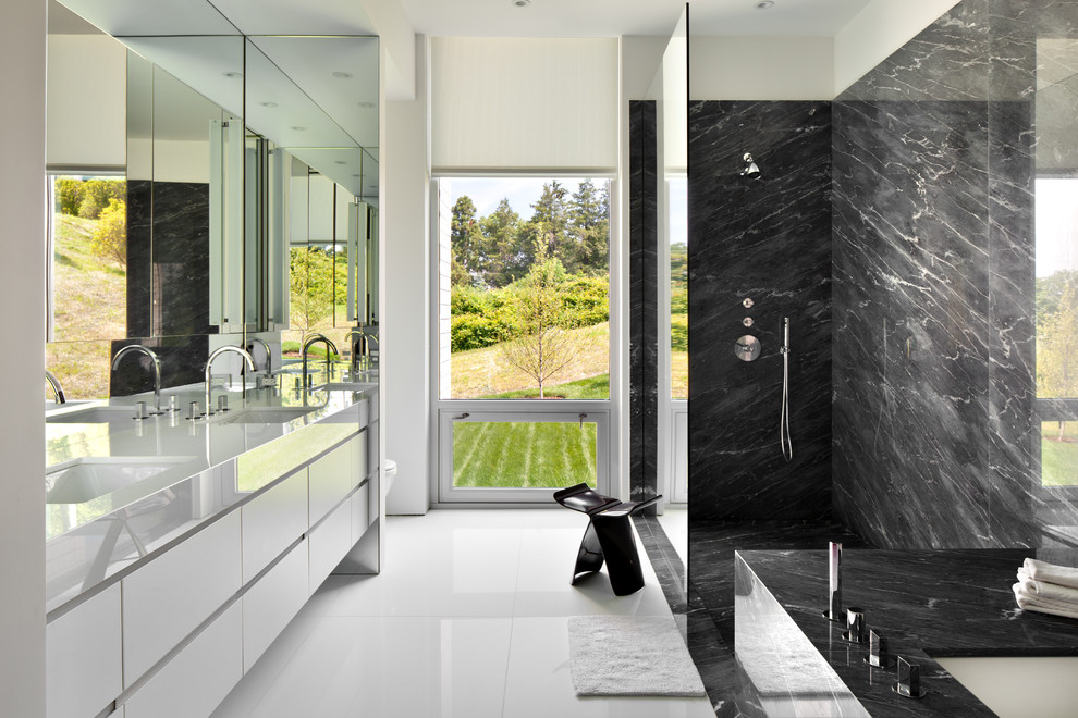 Contemporary master bathroom in New York with an undermount sink, flat-panel cabinets, white cabinets, an undermount tub, black tile, white walls and a curbless shower.