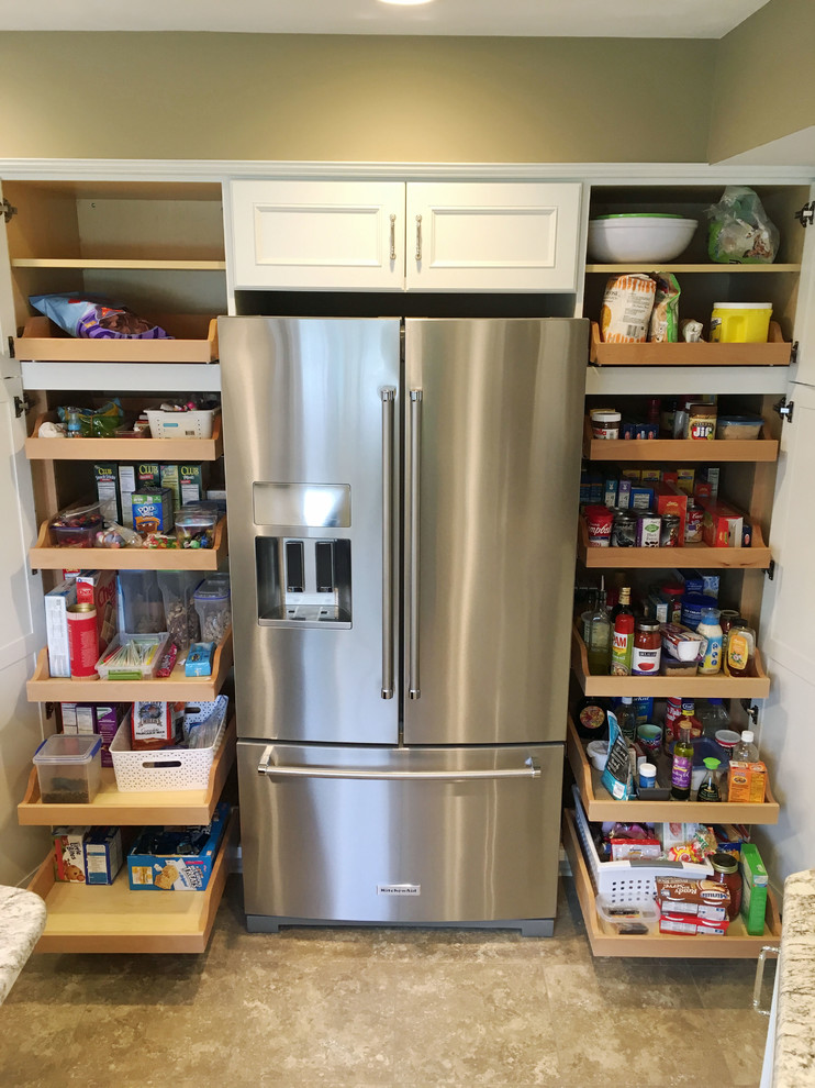 Inspiration for a large transitional l-shaped vinyl floor and beige floor eat-in kitchen remodel with a double-bowl sink, recessed-panel cabinets, white cabinets, granite countertops, brown backsplash, ceramic backsplash, stainless steel appliances and an island