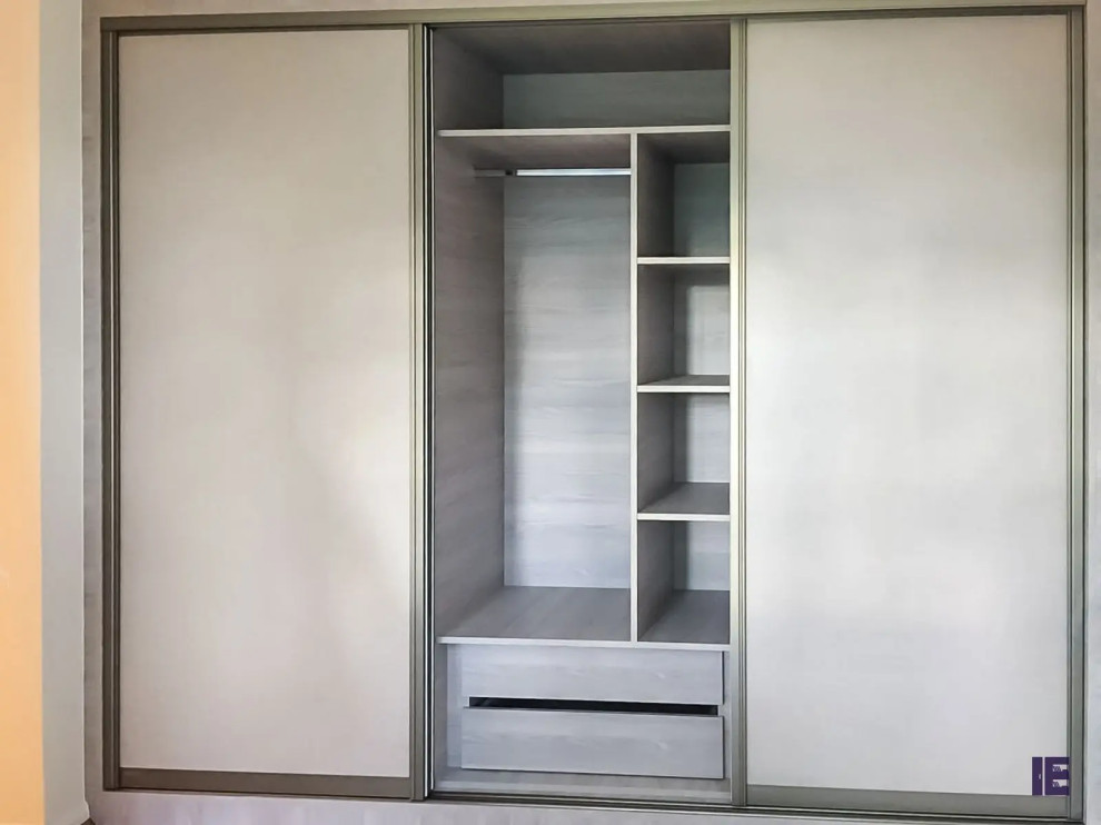 Photo of a small contemporary standard wardrobe in London with flat-panel cabinets, grey cabinets, plywood flooring and brown floors.