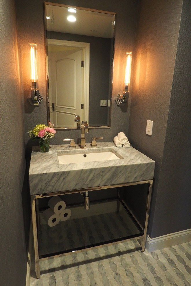 This is an example of a mid-sized transitional powder room in Los Angeles with open cabinets, grey walls, marble floors, an undermount sink, marble benchtops, multi-coloured floor and grey benchtops.