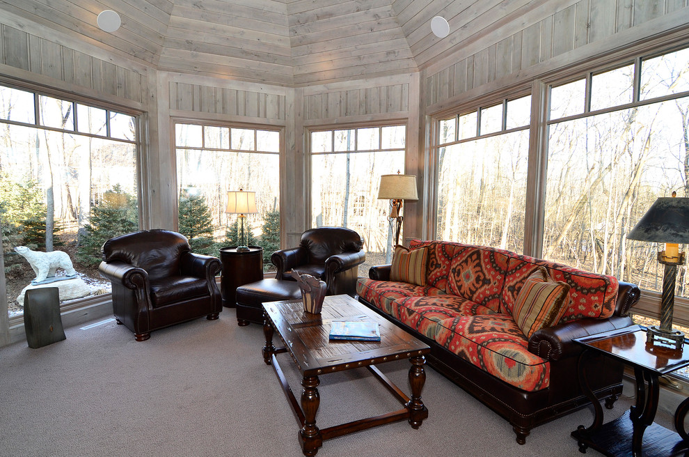 Photo of a large traditional enclosed family room in Minneapolis with carpet and grey walls.