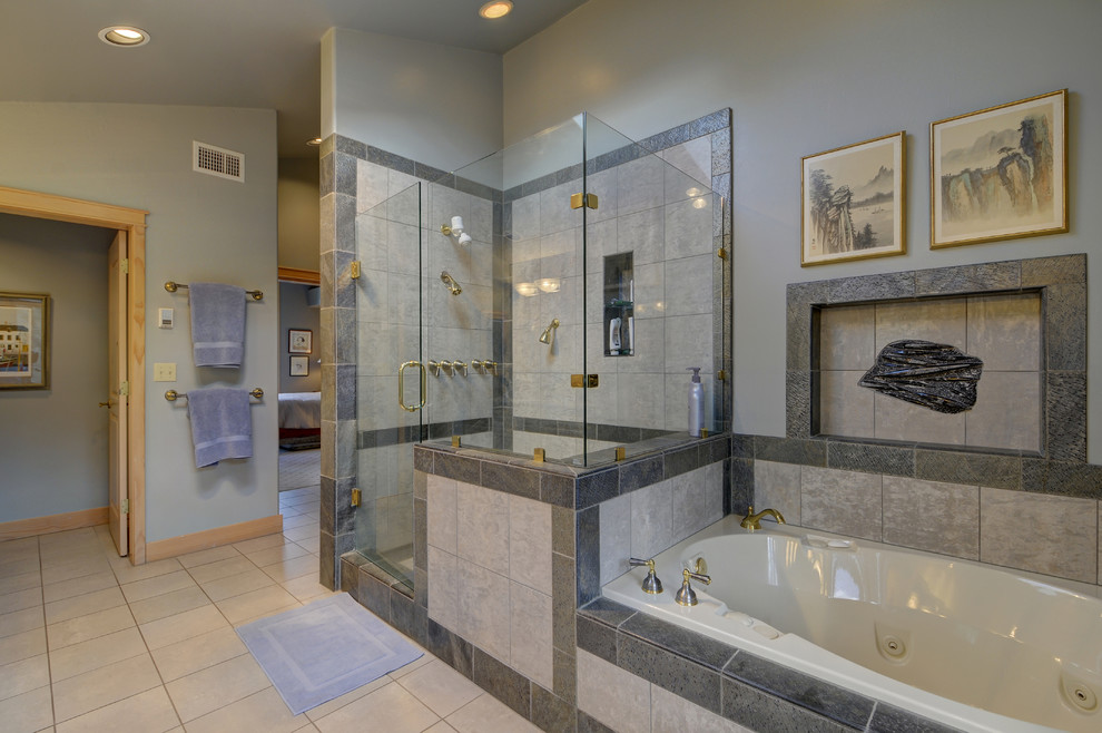 Photo of a large contemporary master bathroom in Other with raised-panel cabinets, light wood cabinets, a freestanding tub, a corner shower, a wall-mount toilet, white tile, porcelain tile, porcelain floors, an integrated sink, tile benchtops, brown floor and a hinged shower door.