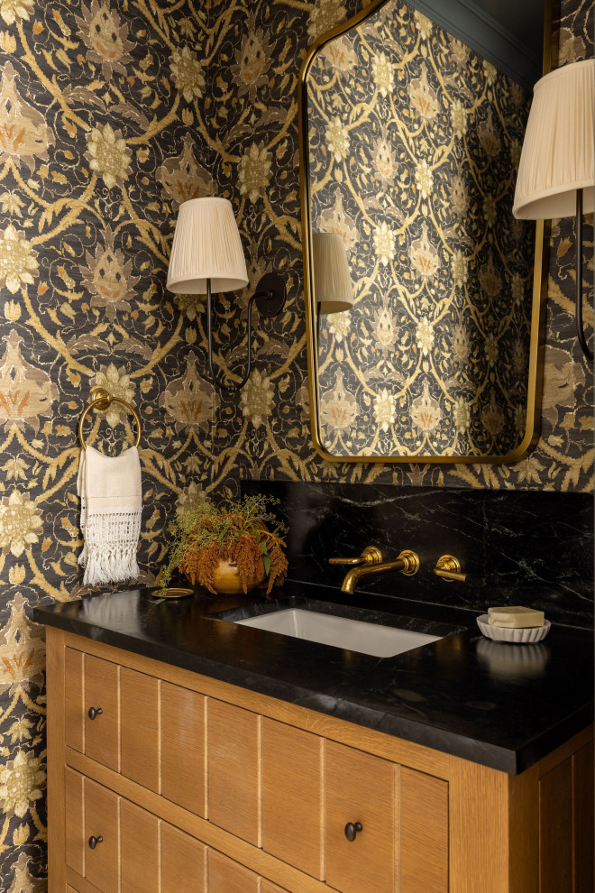 Design ideas for a traditional cloakroom in Sacramento with flat-panel cabinets, medium wood cabinets, a submerged sink, black worktops, a freestanding vanity unit and wallpapered walls.