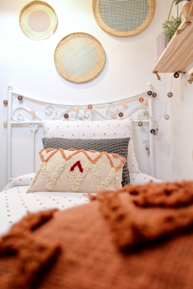 This is an example of a small beach style kids' room for girls in Other with white walls, dark hardwood floors, brown floor and vaulted.