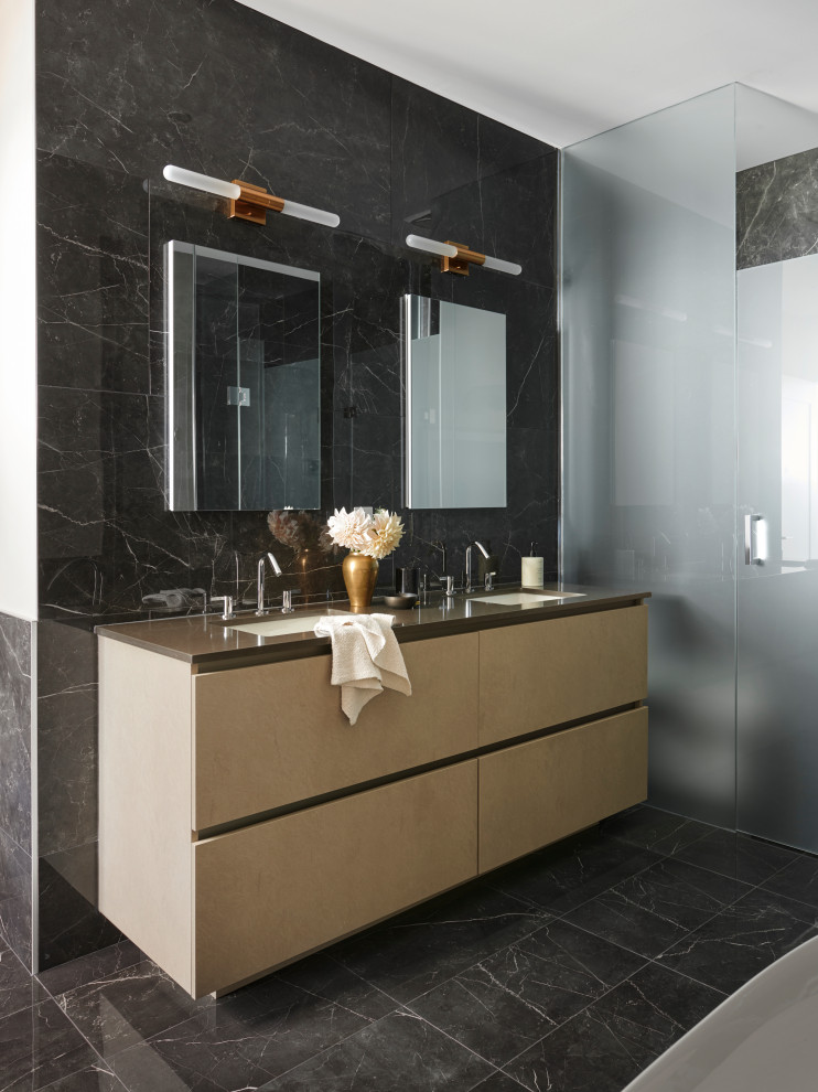 This is an example of a large contemporary master bathroom in Toronto with flat-panel cabinets, beige cabinets, a freestanding tub, a two-piece toilet, black tile, porcelain tile, beige walls, porcelain floors, engineered quartz benchtops, black floor, a hinged shower door, brown benchtops, an enclosed toilet, a double vanity, a floating vanity, an alcove shower and an undermount sink.
