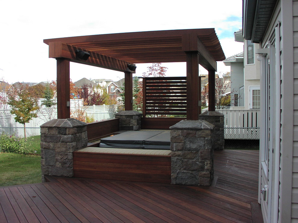 Inspiration for a traditional backyard deck in Calgary with a pergola.