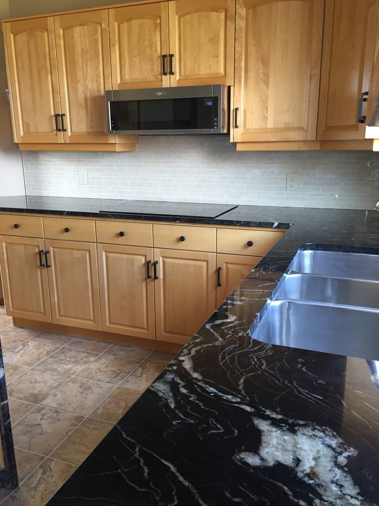 Example of a porcelain tile kitchen design with quartz countertops, ceramic backsplash and gray countertops