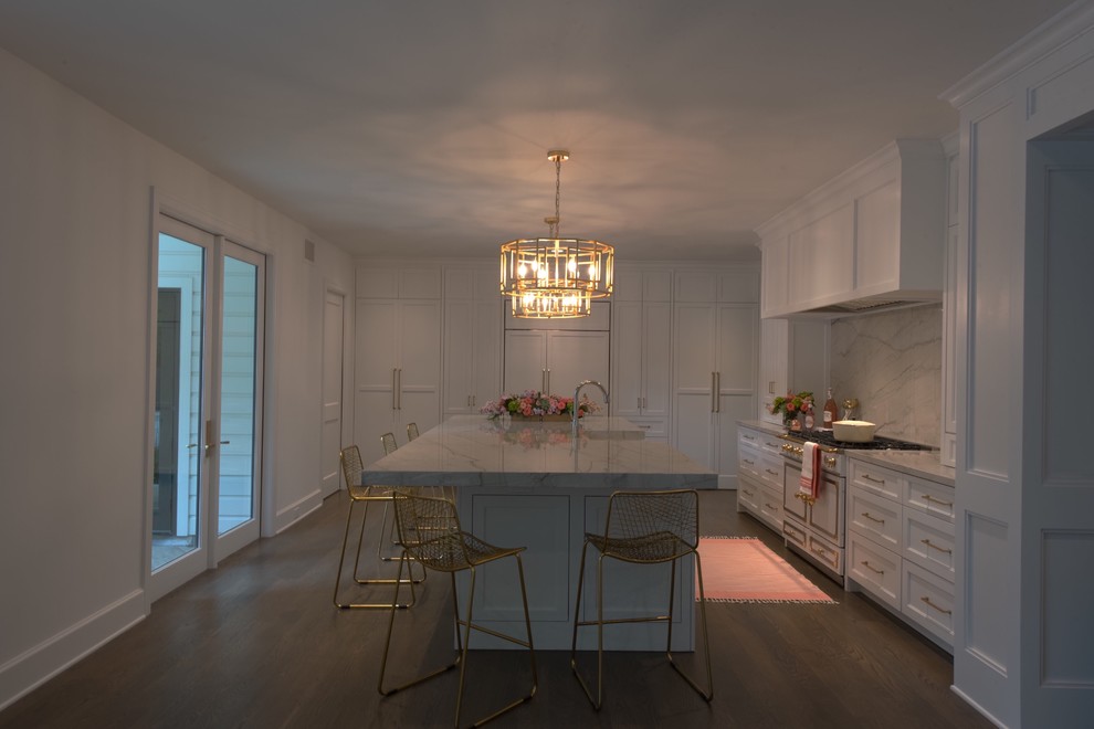 Inspiration for a large transitional l-shaped medium tone wood floor and brown floor open concept kitchen remodel with a farmhouse sink, recessed-panel cabinets, white cabinets, quartzite countertops, white backsplash, stone slab backsplash, paneled appliances and an island