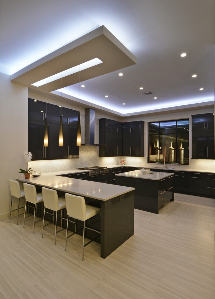 Contemporary u-shaped kitchen in Austin with flat-panel cabinets, black cabinets, with island and beige floor.