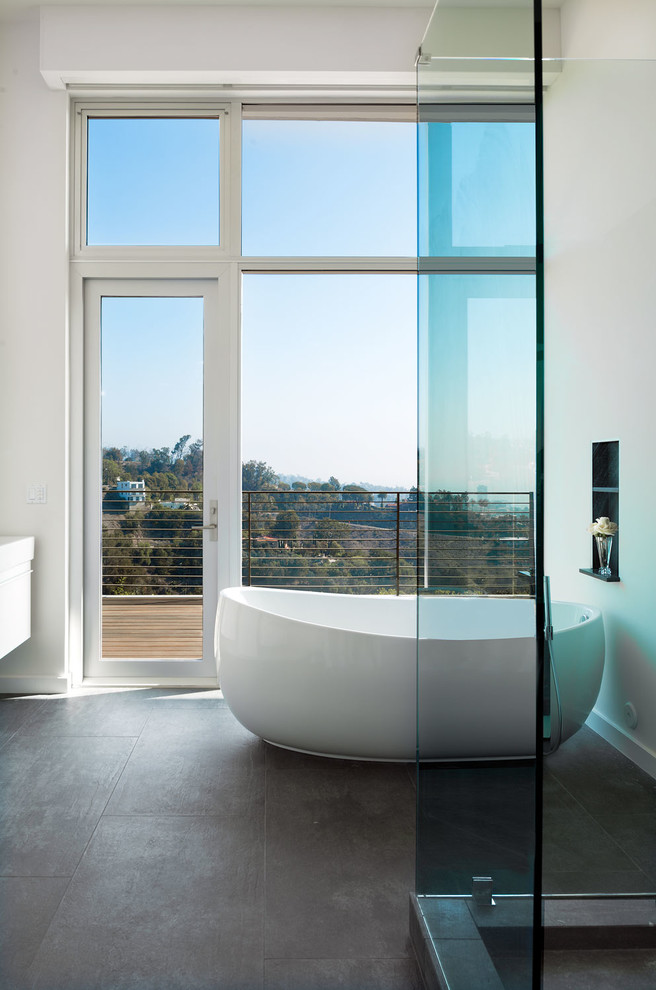 Photo of a contemporary bathroom in Los Angeles with a freestanding tub, a corner shower and white walls.