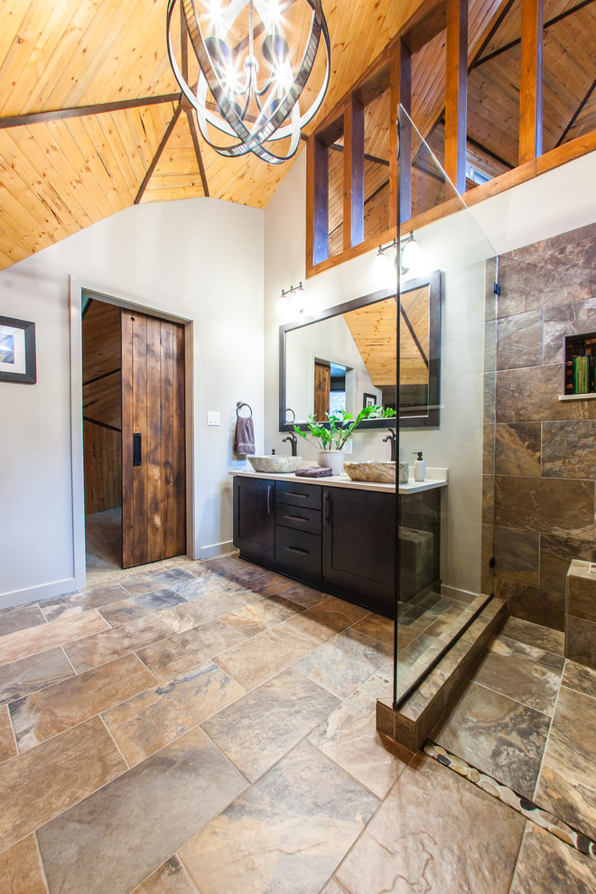 Photo of a mid-sized country master bathroom in Other with a vessel sink, shaker cabinets, engineered quartz benchtops, a freestanding tub, an open shower, a one-piece toilet, porcelain tile, grey walls, porcelain floors, an open shower, dark wood cabinets, multi-coloured tile and multi-coloured floor.