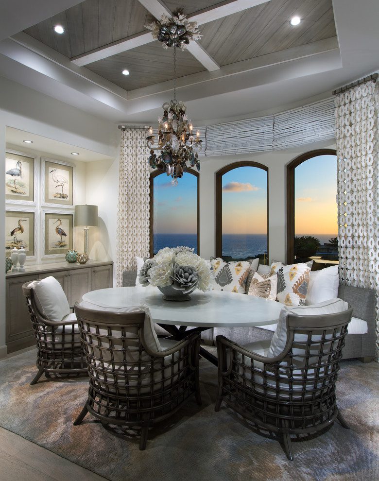 Mid-sized beach style dining room in Orange County with white walls.