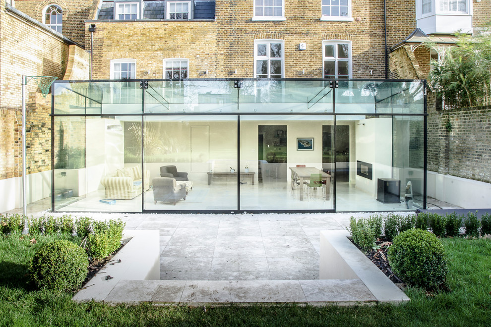 This is an example of a large contemporary one-storey glass exterior in London.