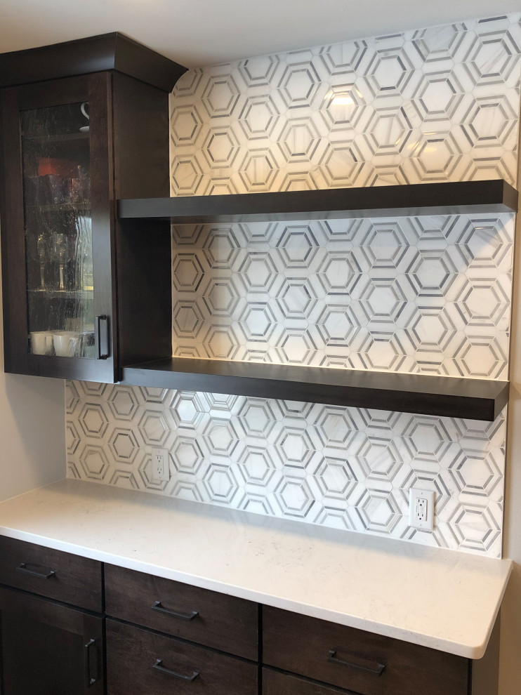 Example of a mid-sized transitional galley light wood floor and brown floor eat-in kitchen design with an undermount sink, shaker cabinets, black cabinets, quartz countertops, gray backsplash, subway tile backsplash, stainless steel appliances, no island and white countertops