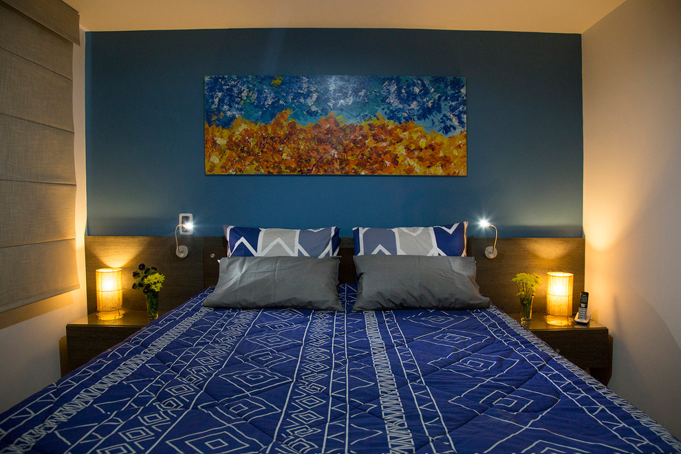 Small contemporary master bedroom in Other with blue walls and medium hardwood floors.