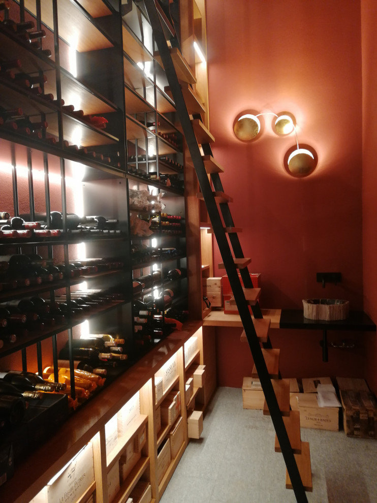 Mid-sized arts and crafts wine cellar in Milan with marble floors, display racks and grey floor.