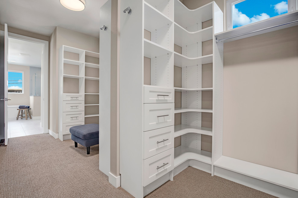 Design ideas for a contemporary walk-in wardrobe in Seattle with white cabinets and carpet.