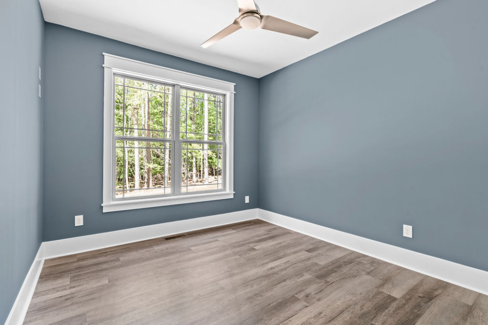 This is an example of a medium sized traditional multi-use home gym in Raleigh with blue walls, vinyl flooring and grey floors.