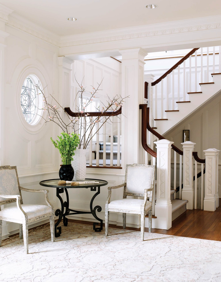 Design ideas for a traditional foyer in Bridgeport with white walls and medium hardwood floors.
